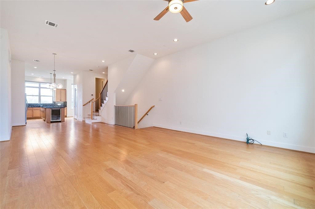 194 Harvard Street Houston, TX 77007 - Photo 11 of 43 an empty room with wooden floor and windows
