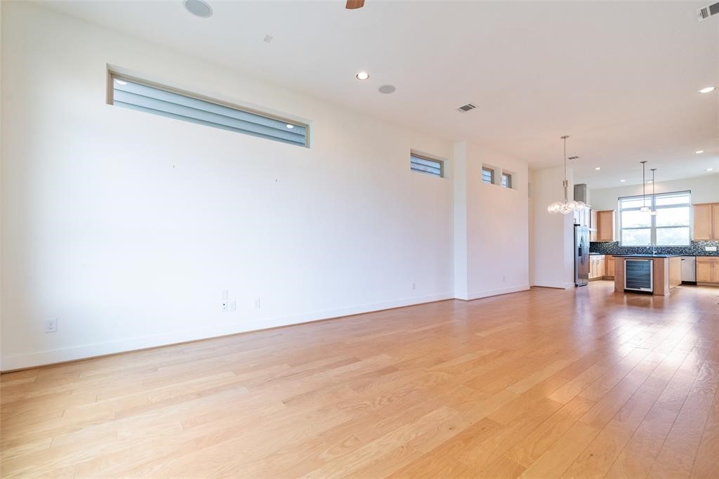 194 Harvard Street Houston, TX 77007 - Photo 12 of 43 a view of empty room with wooden floor