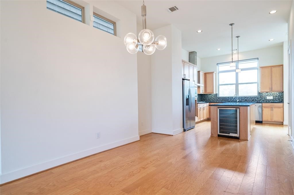 194 Harvard Street Houston, TX 77007 - Photo 15 of 43 a view of a kitchen with a refrigerator and a large window