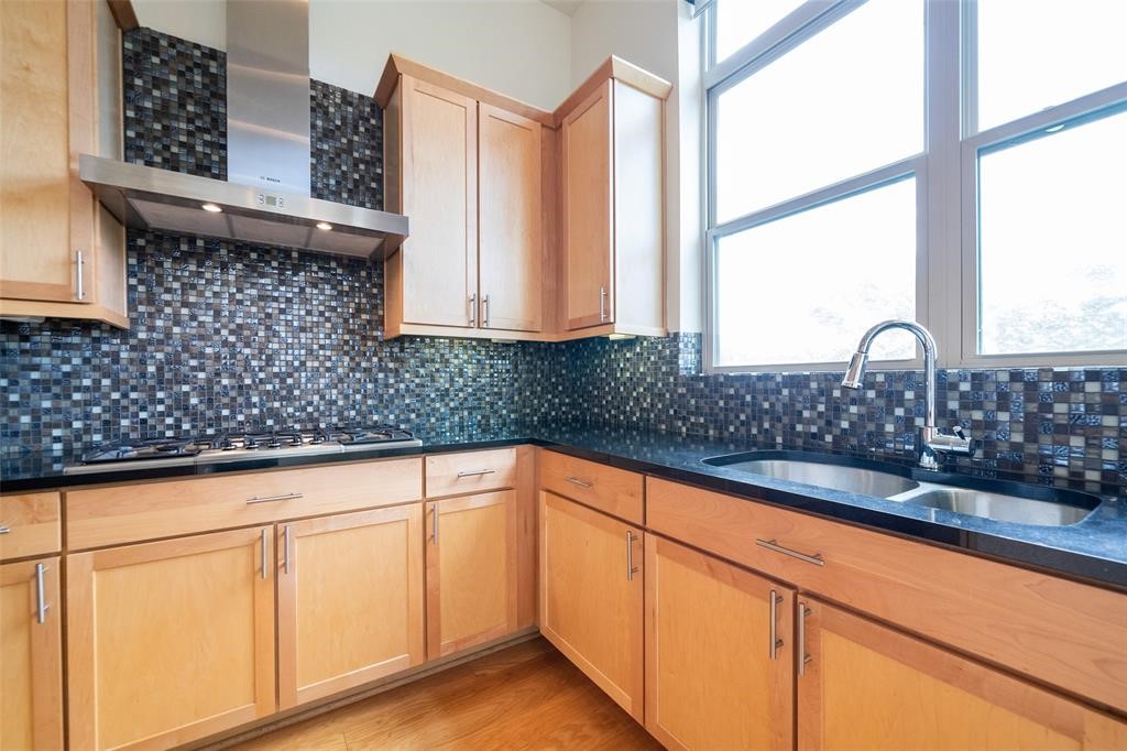 194 Harvard Street Houston, TX 77007 - Photo 16 of 43 a kitchen with stainless steel appliances white cabinets and a large window