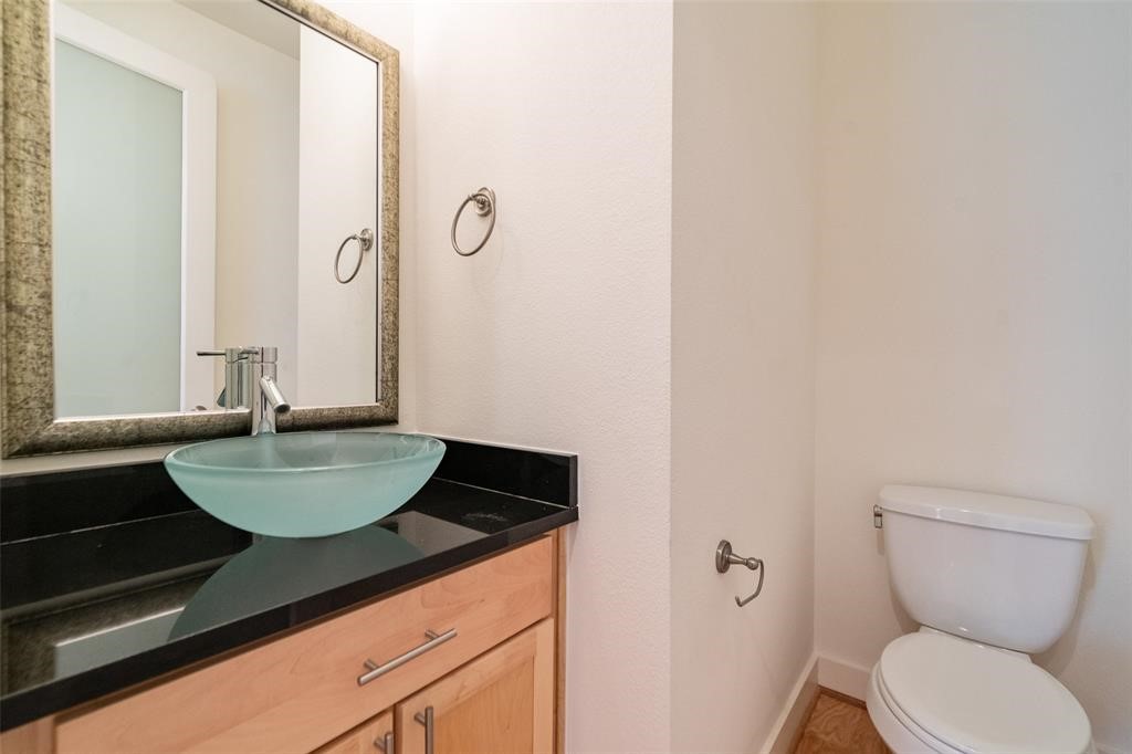 194 Harvard Street Houston, TX 77007 - Photo 19 of 43 a bathroom with a granite countertop sink and a mirror