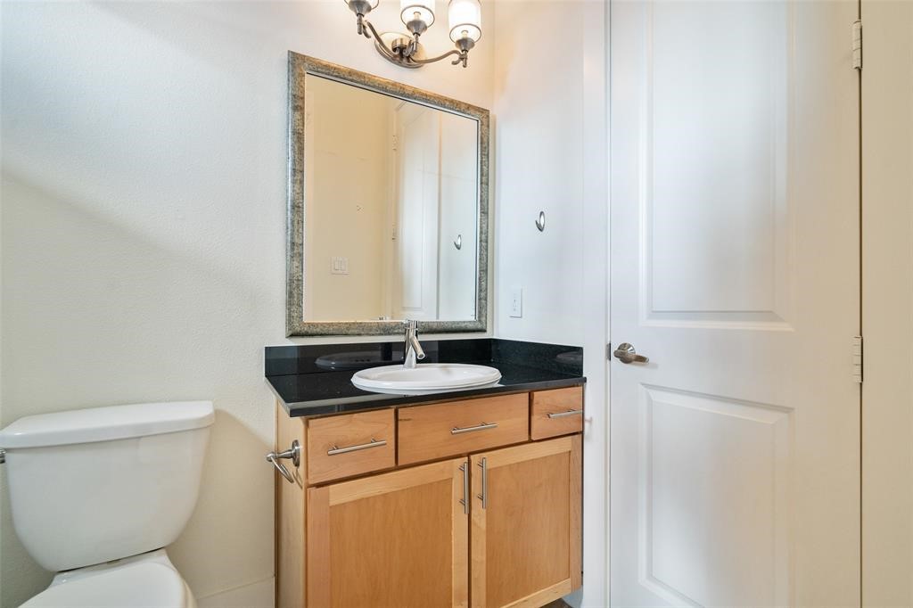194 Harvard Street Houston, TX 77007 - Photo 36 of 43 a bathroom with a granite countertop sink and a toilet