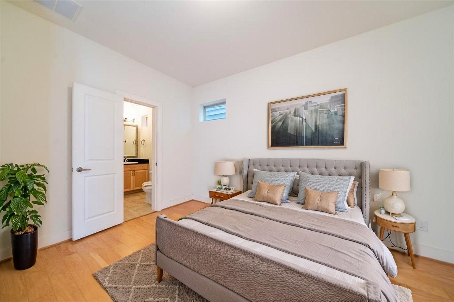 194 Harvard Street Houston, TX 77007 - Photo 4 of 43 a bedroom with a bed and a potted plant