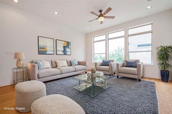 a kitchen with stainless steel appliances white cabinets and a large window