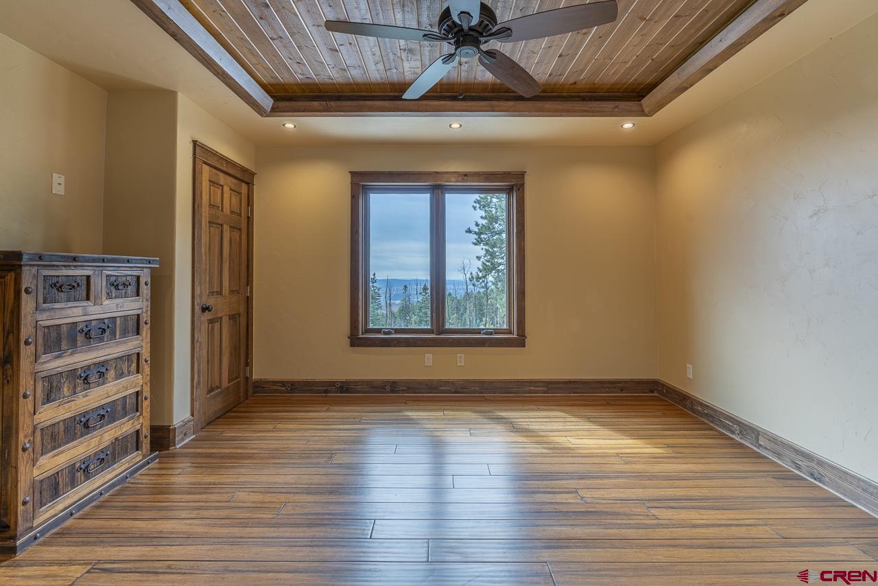 1550 Silver Mesa Driveway Durango, CO 81301 - Photo 20 of 34 a view of an empty room with a window and wooden floor