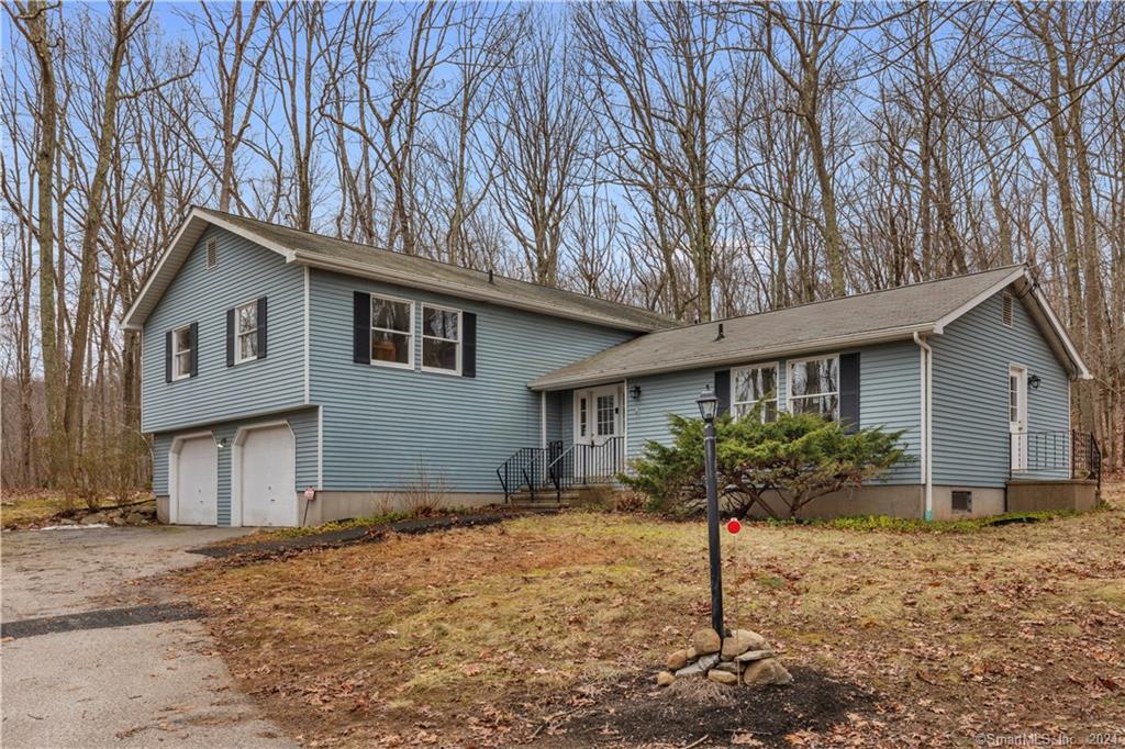a house that has a tree in front of it