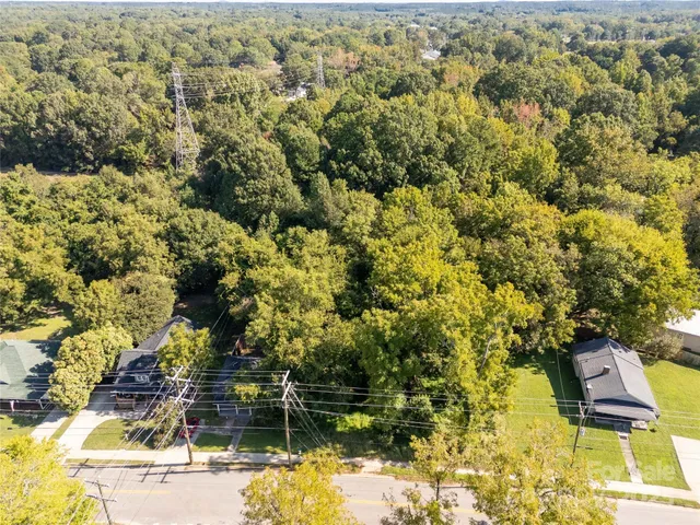 an aerial view of residential houses with yard