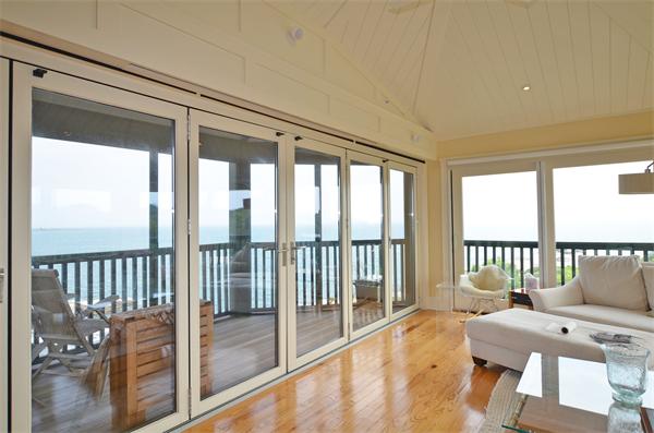 575 Tuckerman Avenue, Unit P Middletown, RI 02842 - Photo 6 of 30 a balcony with furniture and wooden floor