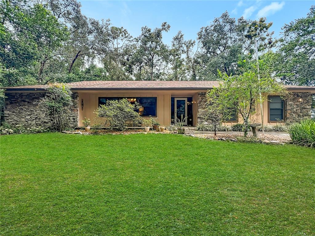 a front view of house with yard and outdoor seating