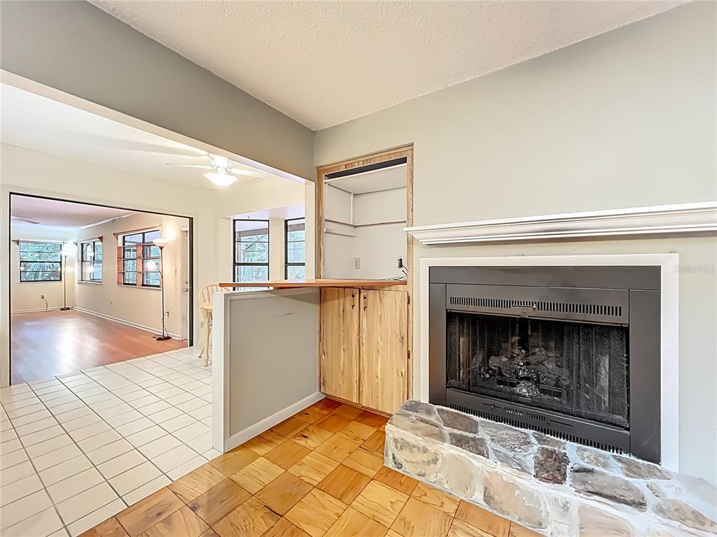 1942 Country Club Road Eustis, FL 32726 - Photo 14 of 56 a living room with a fireplace and a rug
