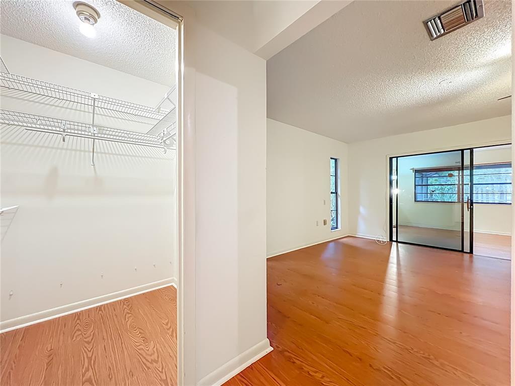 1942 Country Club Road Eustis, FL 32726 - Photo 19 of 56 a view of empty room with wooden floor