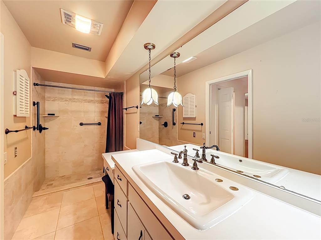 1942 Country Club Road Eustis, FL 32726 - Photo 24 of 56 a bathroom with a sink vanity and a mirror
