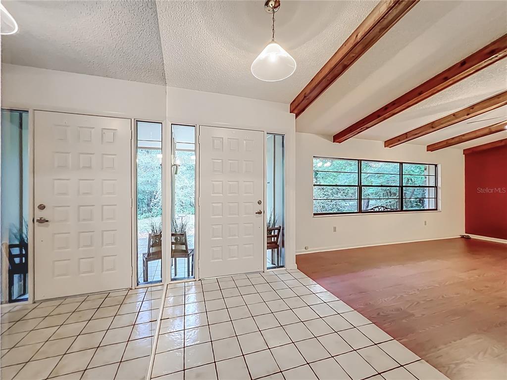 1942 Country Club Road Eustis, FL 32726 - Photo 3 of 56 a view of an empty room with window and chandelier fan