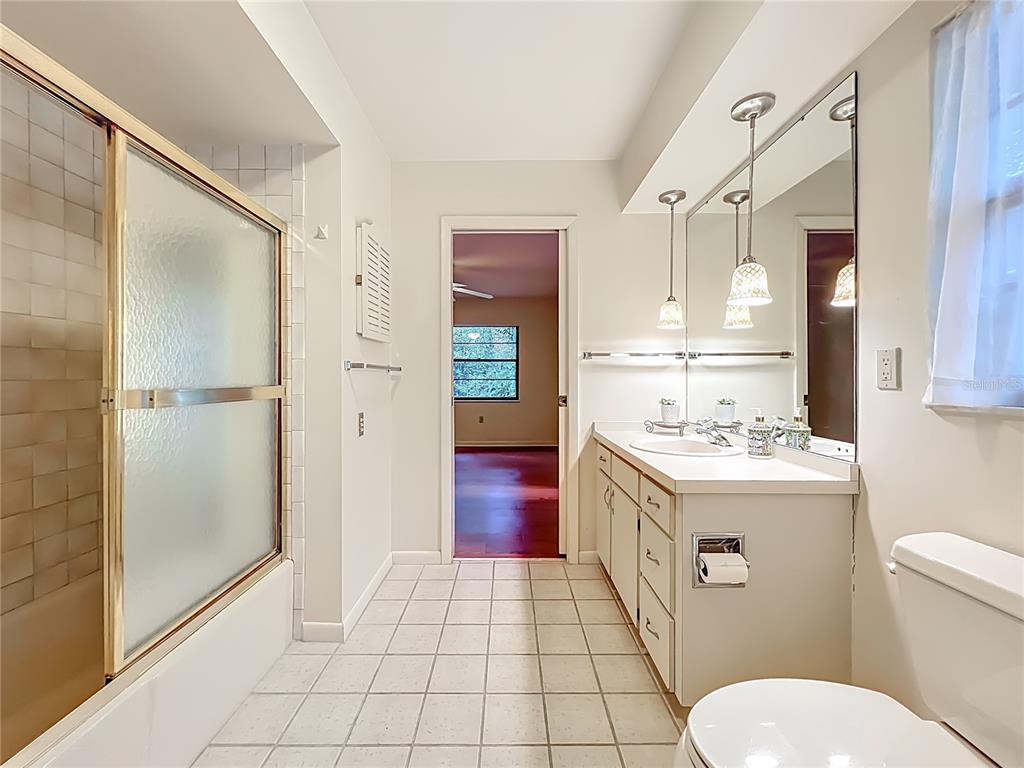 1942 Country Club Road Eustis, FL 32726 - Photo 31 of 56 a bathroom with a granite countertop sink toilet and shower