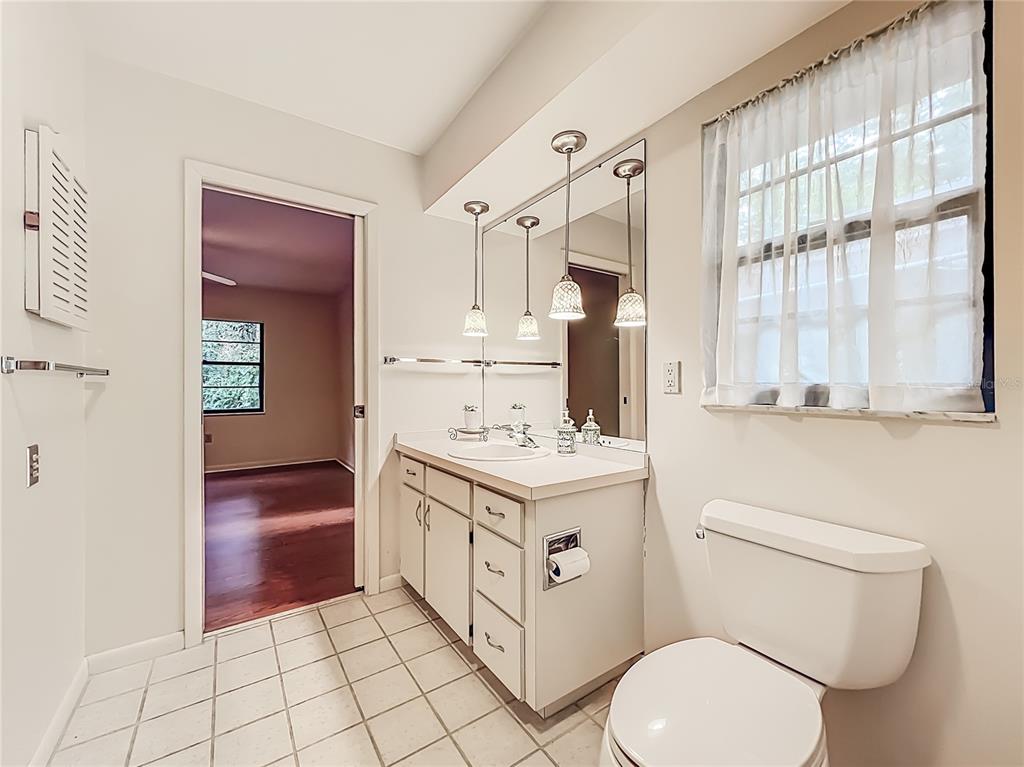 1942 Country Club Road Eustis, FL 32726 - Photo 33 of 56 a bathroom with a sink a toilet and vanity