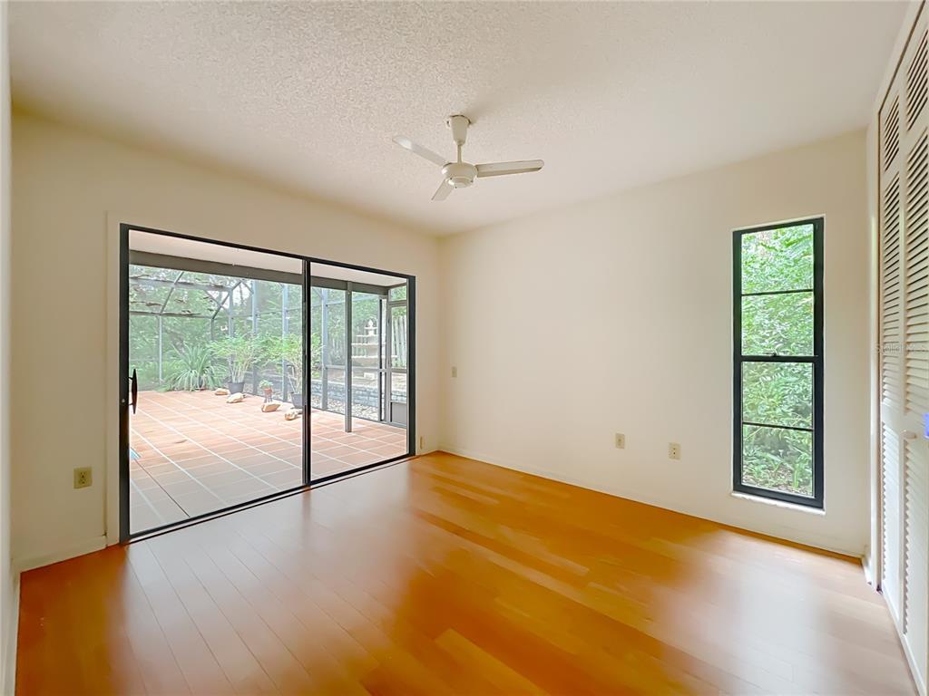 1942 Country Club Road Eustis, FL 32726 - Photo 35 of 56 an empty room with wooden floor and windows
