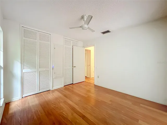 a view of an empty room with glass door and windows