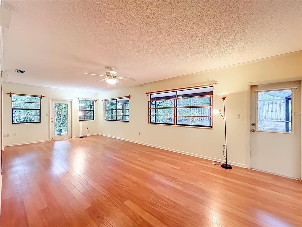 1942 Country Club Road Eustis, FL 32726 - Photo 39 of 56 a view of an empty room with wooden floor and a window