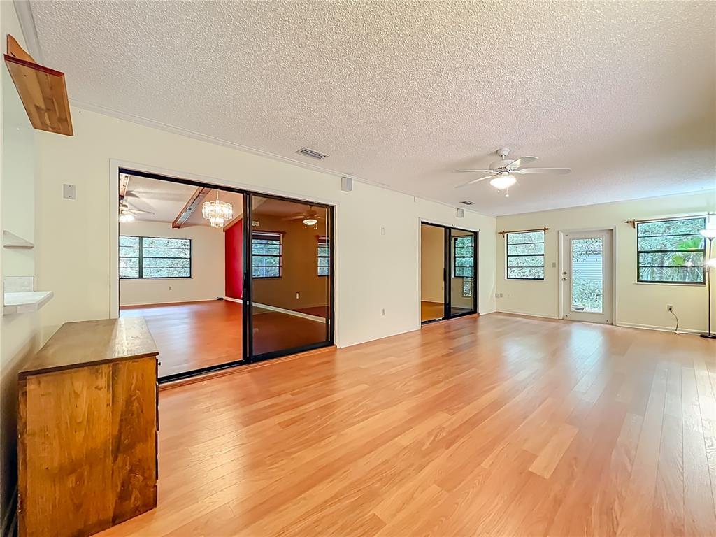 1942 Country Club Road Eustis, FL 32726 - Photo 40 of 56 a view of an empty room with window and wooden floor