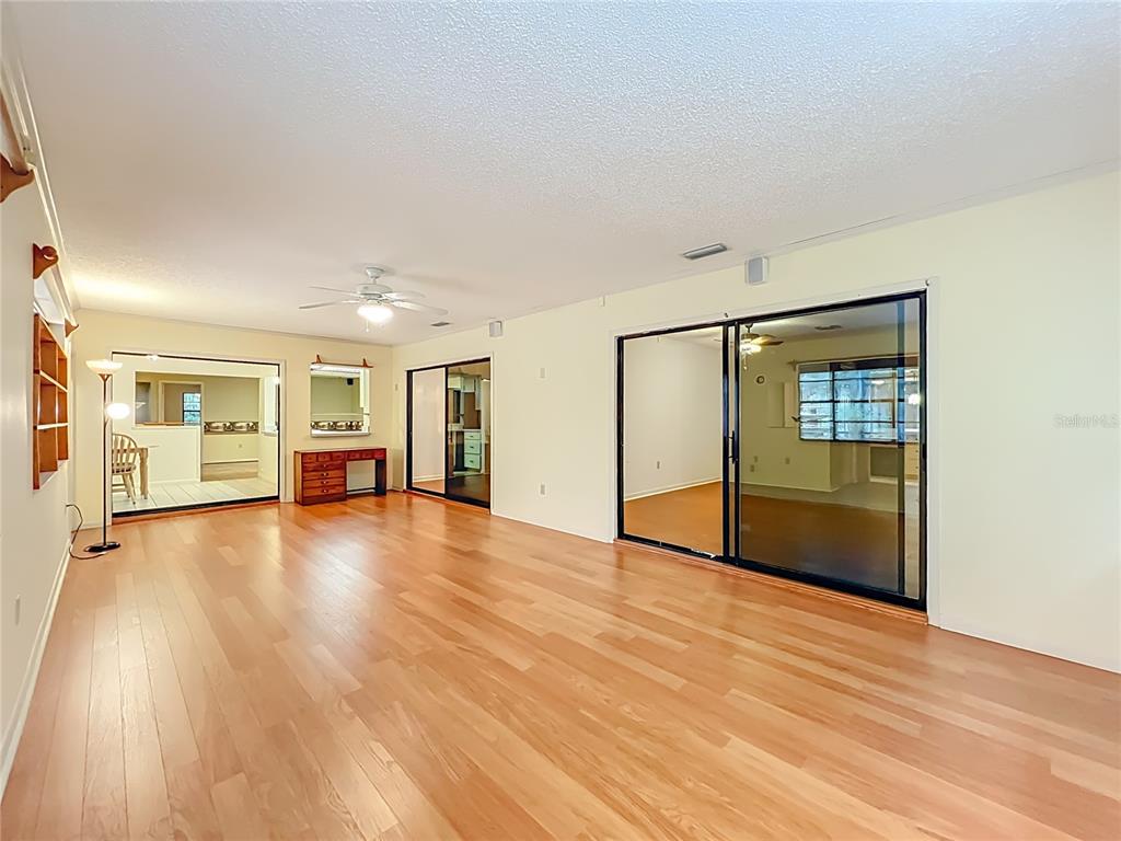 1942 Country Club Road Eustis, FL 32726 - Photo 42 of 56 a view of an empty room with wooden floor and a window