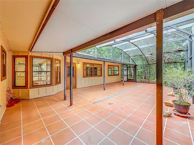 a view of a house with backyard and a tree