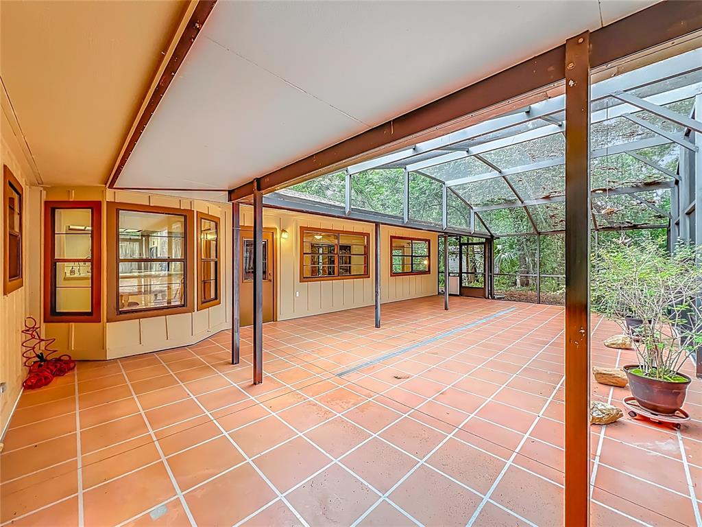 1942 Country Club Road Eustis, FL 32726 - Photo 46 of 56 a view of an empty room with a floor to ceiling windows and pool table