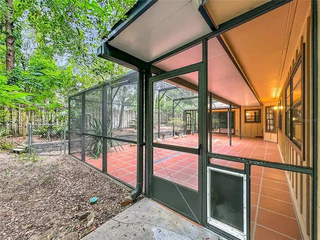 a view of a house with backyard and trees