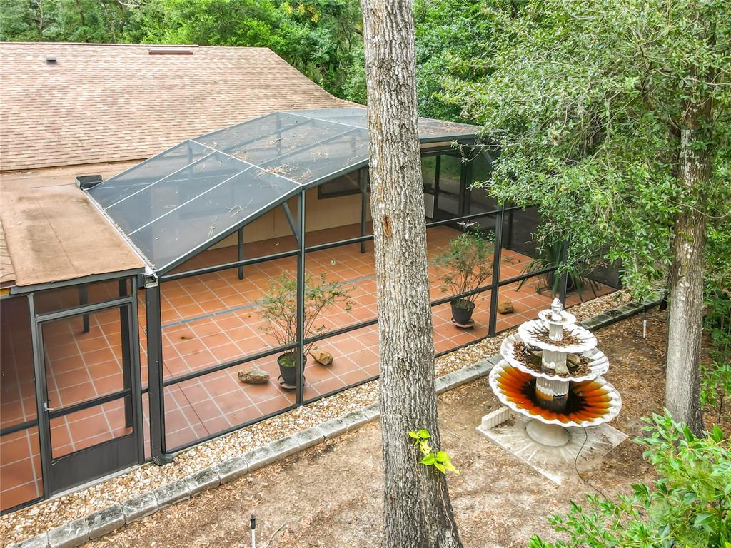 1942 Country Club Road Eustis, FL 32726 - Photo 50 of 56 a picture of a table and a fire pit with wooden fence
