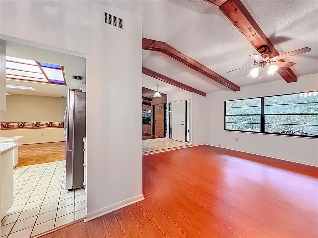 1942 Country Club Road Eustis, FL 32726 - Photo 5 of 56 a view of an empty room with window and wooden floor