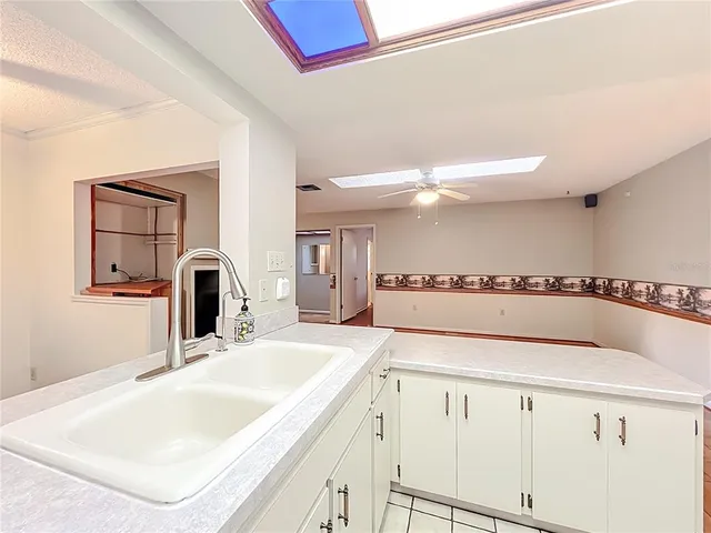 a kitchen with a stove a sink and a microwave