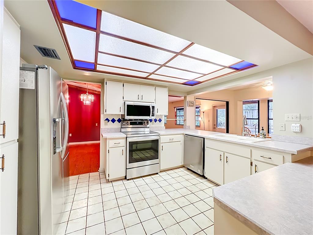 1942 Country Club Road Eustis, FL 32726 - Photo 10 of 56 a kitchen with a stove a sink and a microwave