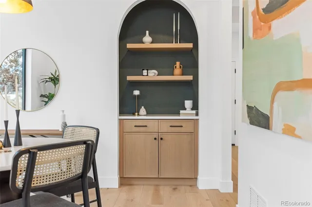 a spacious bathroom with a sink a toilet and a mirror