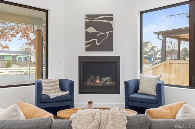 a living room with furniture and a floor to ceiling window