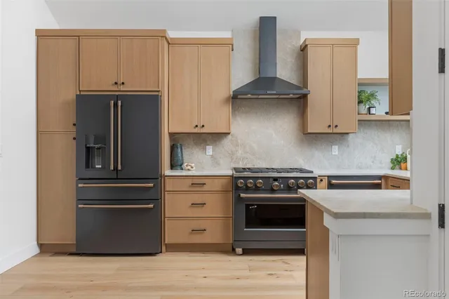 a kitchen with stainless steel appliances granite countertop a stove and a refrigerator