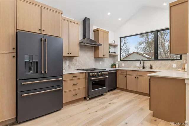 a kitchen with stainless steel appliances granite countertop a refrigerator and a sink