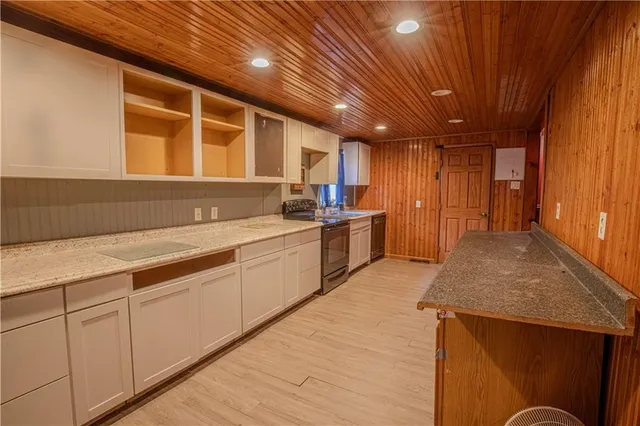 a kitchen with cabinets and wooden floor