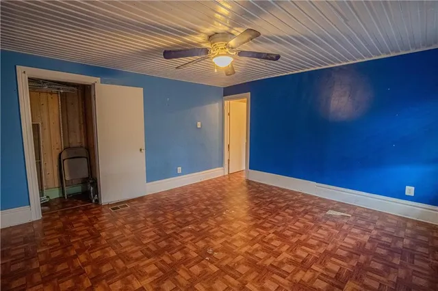 a view of a hallway with wooden floor and entryway