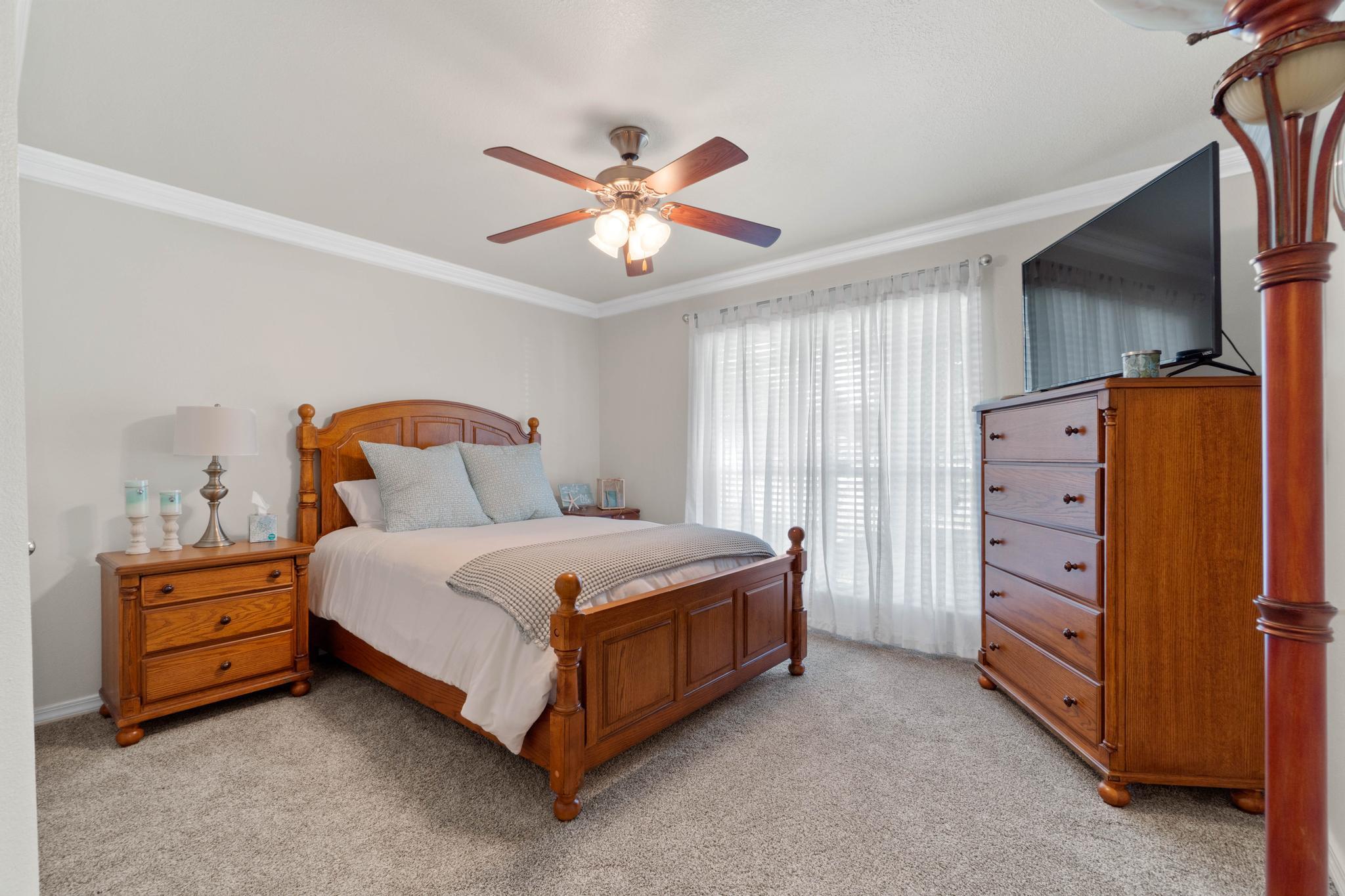 99 Inlet Drive Santa Rosa Beach, FL 32459 - Photo 28 of 52 a bedroom with a bed and a chandelier