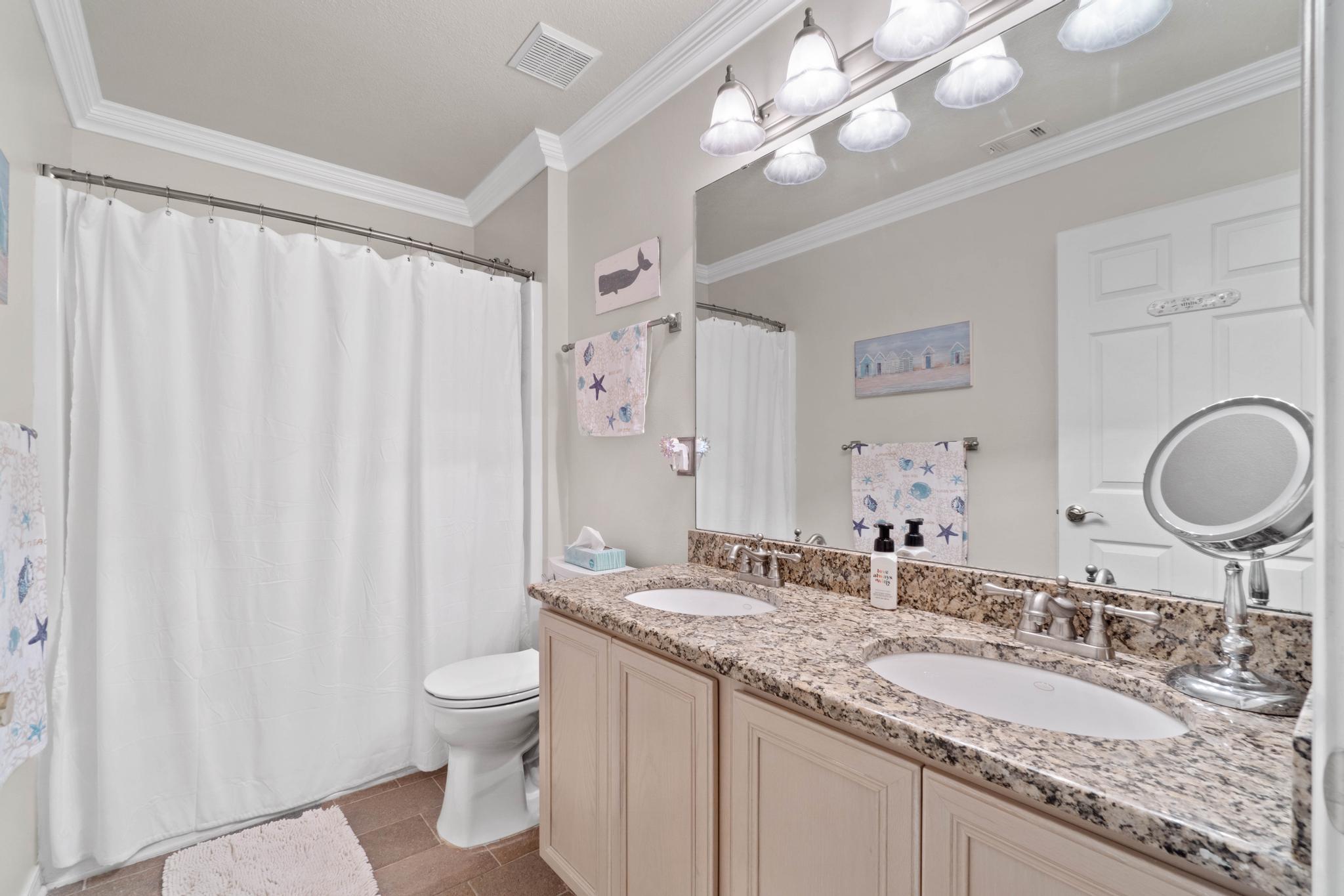 99 Inlet Drive Santa Rosa Beach, FL 32459 - Photo 31 of 52 a bathroom with a granite countertop double vanity sink mirror and toilet
