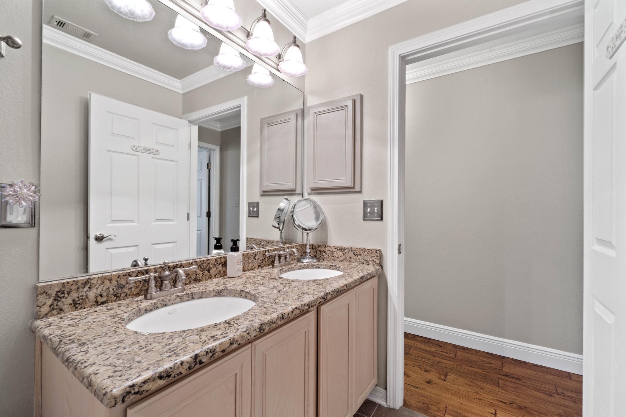99 Inlet Drive Santa Rosa Beach, FL 32459 - Photo 32 of 52 a bathroom with a granite countertop sink and a mirror