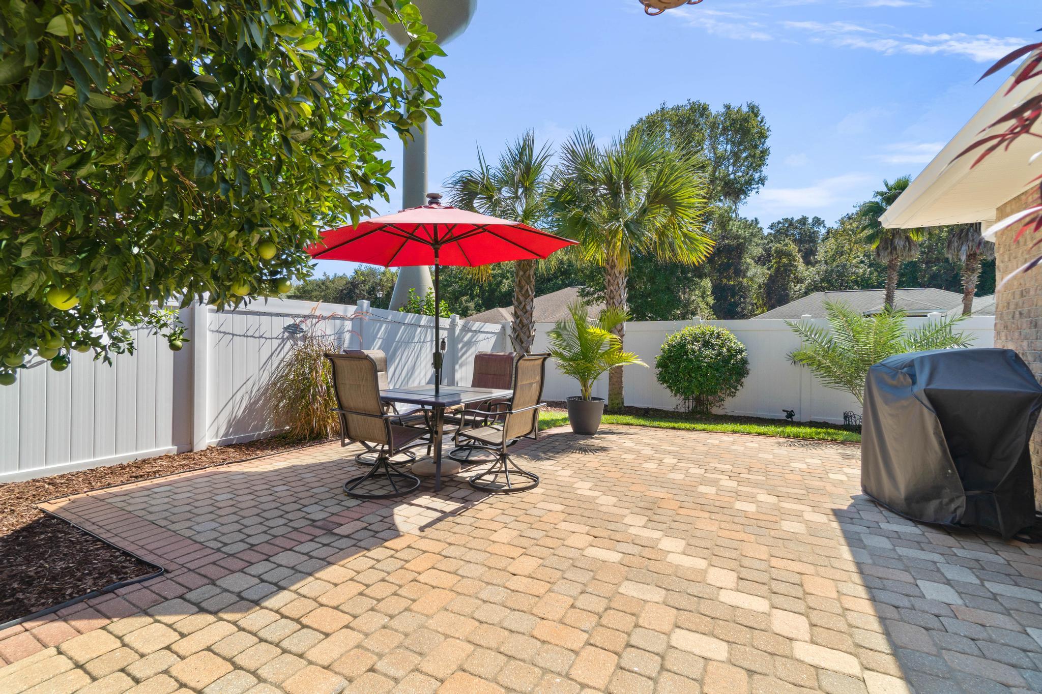 99 Inlet Drive Santa Rosa Beach, FL 32459 - Photo 49 of 52 a view of a patio with a table and chairs under an umbrella