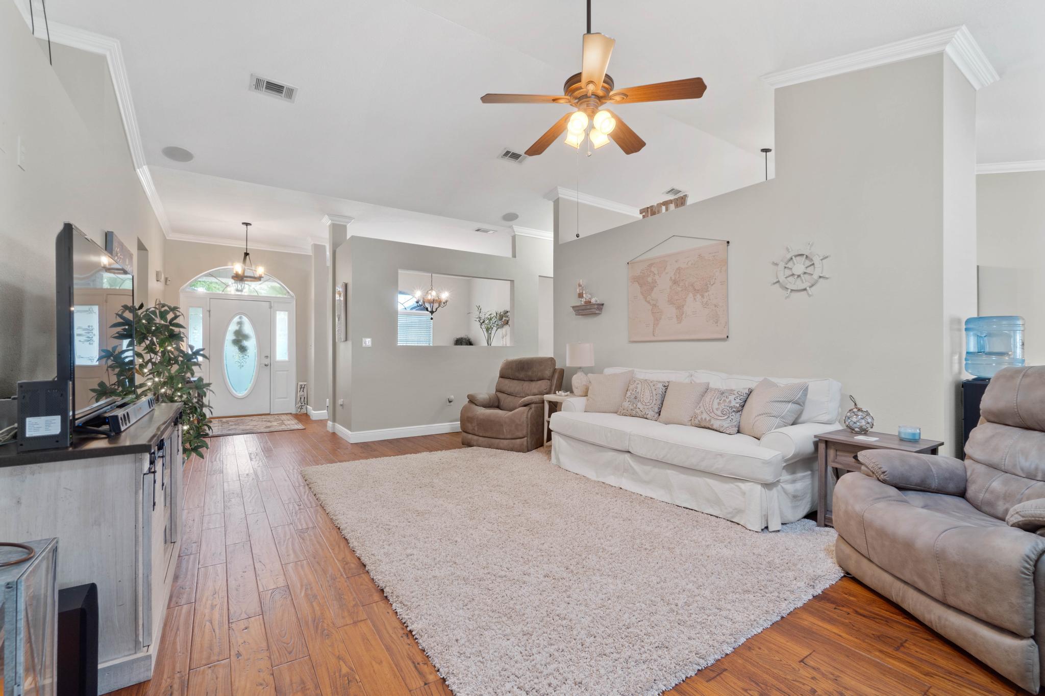 99 Inlet Drive Santa Rosa Beach, FL 32459 - Photo 5 of 52 a living room with furniture a chandelier and a wooden floor