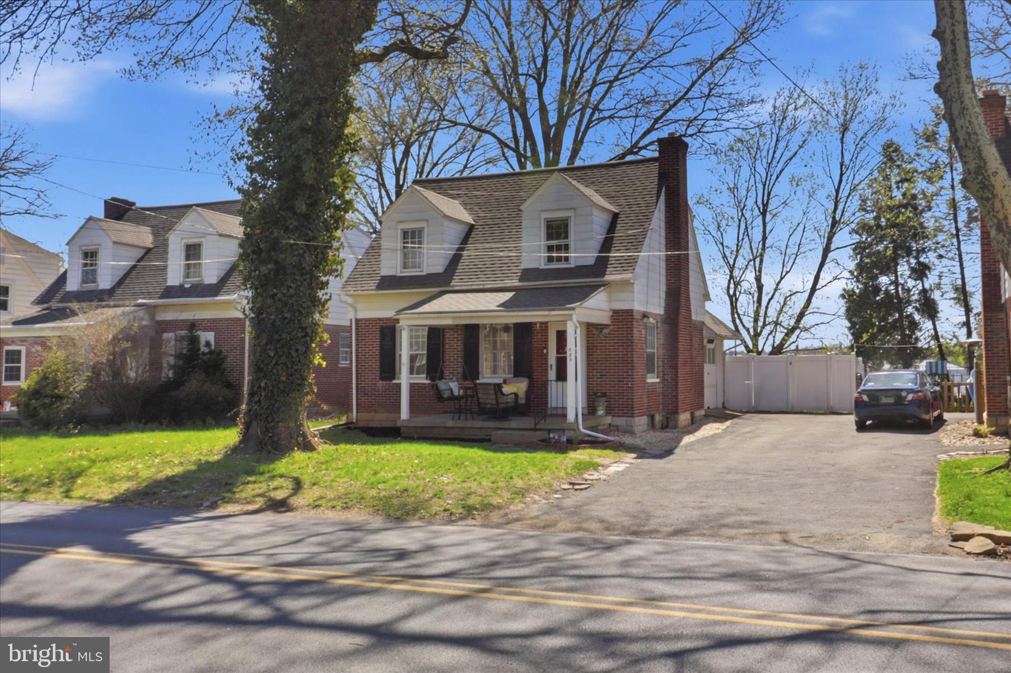 a view of a house with a yard and tree s