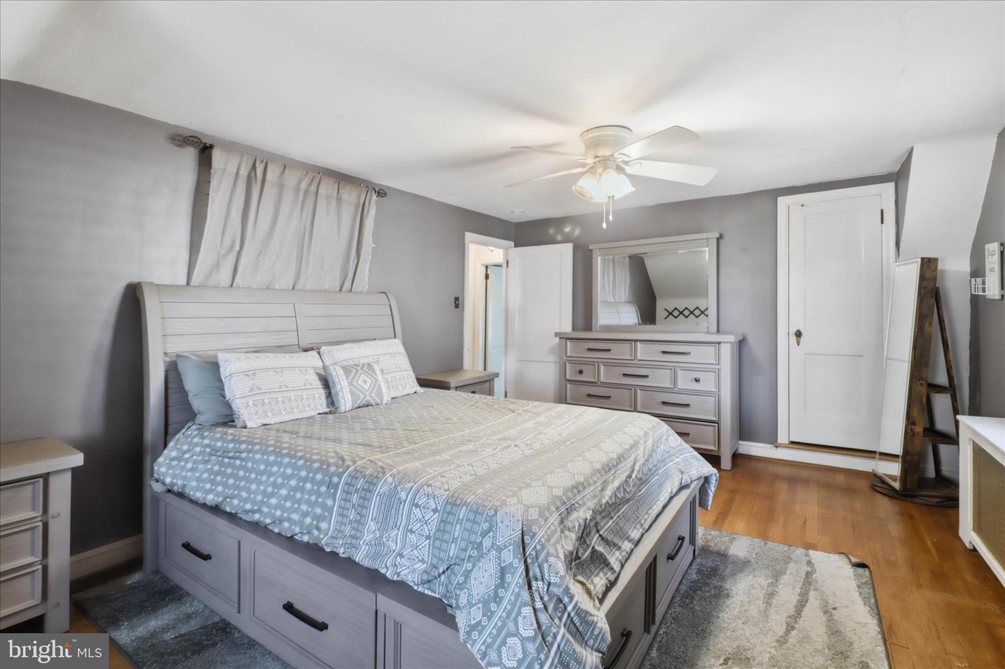 523 Pleasure Road Lancaster, PA 17601 - Photo 12 of 24 a bedroom with a bed flat screen tv and a fireplace