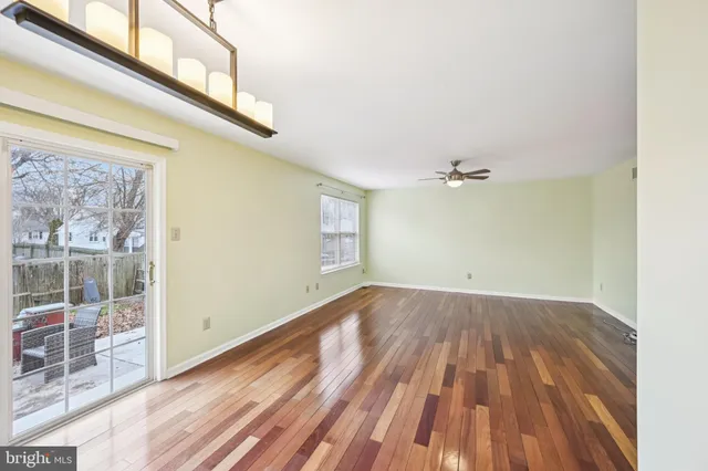 a view of a room with wooden floor and fan