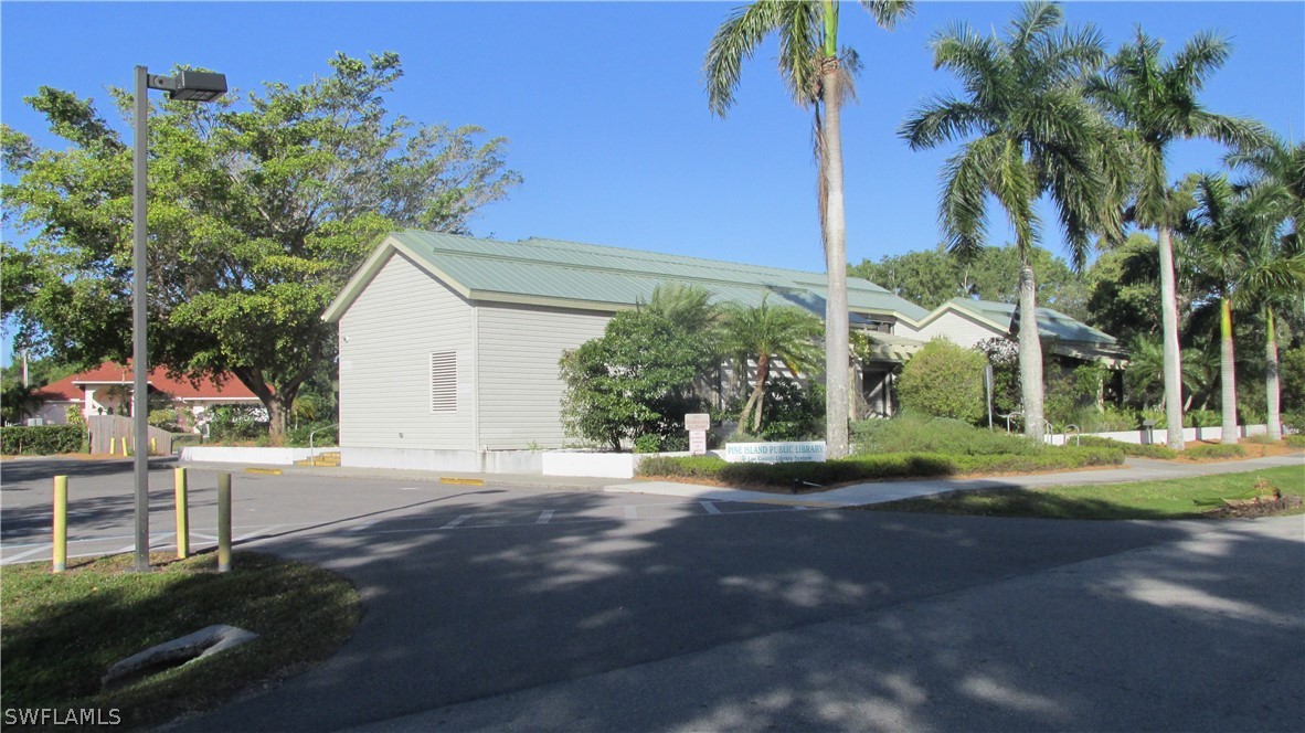 10670 Russell Road Bokeelia, FL 33922 - Photo 6 of 6 a front view of a house with a yard and garage