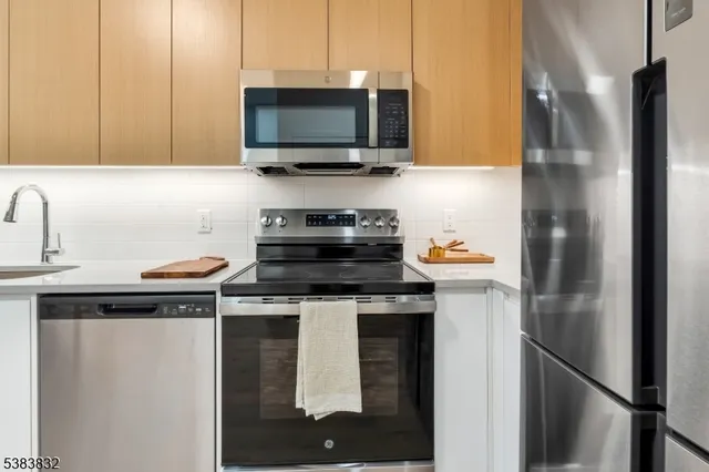 a kitchen with appliances a sink and cabinets