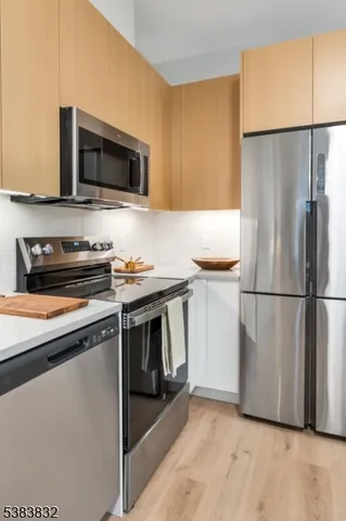 a kitchen with a refrigerator stove and microwave
