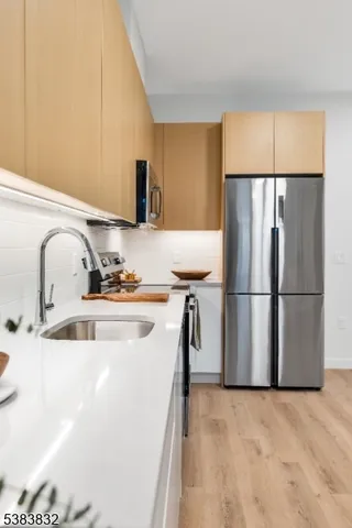 a kitchen with stainless steel appliances a refrigerator and a sink