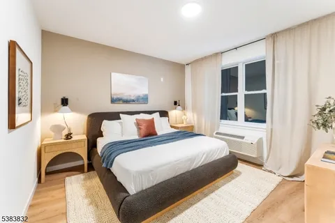 a bedroom with a large bed and a window